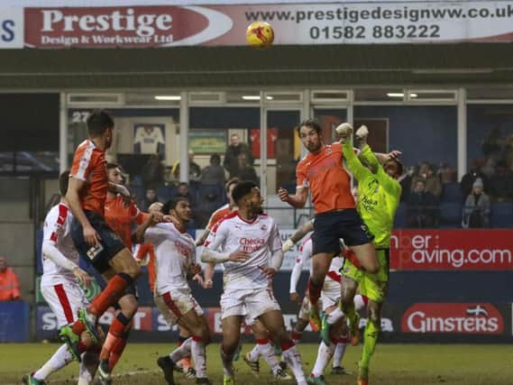 Danny Hylton challenges Crawley keeper Glenn Morris for the free kick that led to his first goal on Saturday