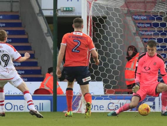 Matt Macey is unable to prevent Alfie May from equalising for Doncaster
