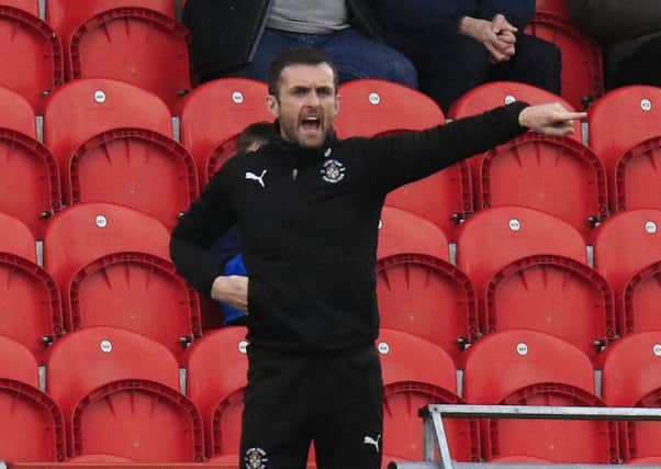 Hatters boss Nathan Jones points from the sidelines at Doncaster