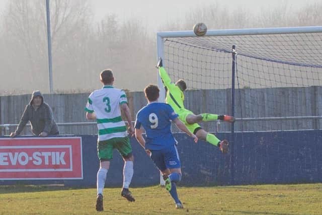Aylesbury United's keeper is powerless to prevent Charlie Smith's free kick from flying in - pic: Greg Childs
