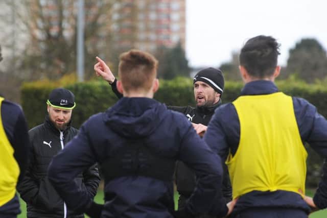 Nathan Jones addresses his squad at their new training ground