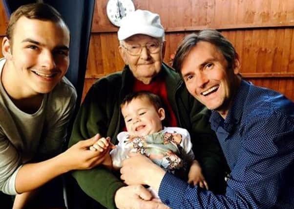 Aaron (far right) with his dad, son and grandson