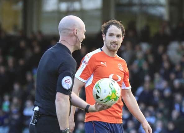 Danny Hylton shares a word with refere Kevin Johnson at the weekend