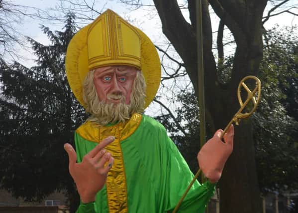A replica of St Patrick leads the parade