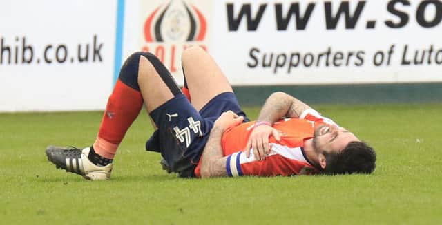 Hatters defender Alan Sheehan suffers his shoulder injury against Exeter
