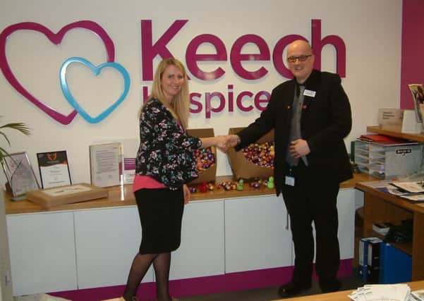 Keech fundraiser Caron Hooper with on board service manager Colin Latimer Parry and some of the 900 Easter eggs that were donated by Thameslink and Great Northern
