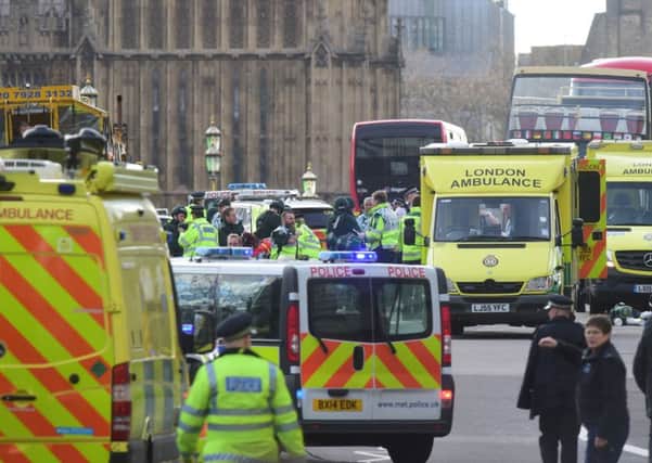 Emergency personnel on Westminster Bridge, close to the Palace of Westminster, London, after at least two people have died after a knifeman brought terror to the heart of Westminster, mowing down pedestrians then stabbing a policeman before he was shot by armed officers. PRESS ASSOCIATION Photo. Picture date: Wednesday March 22, 2017. See PA story POLICE Westminster. Photo credit should read: Lauren Hurley/PA Wire POLICE_Westminster_172300.JPG