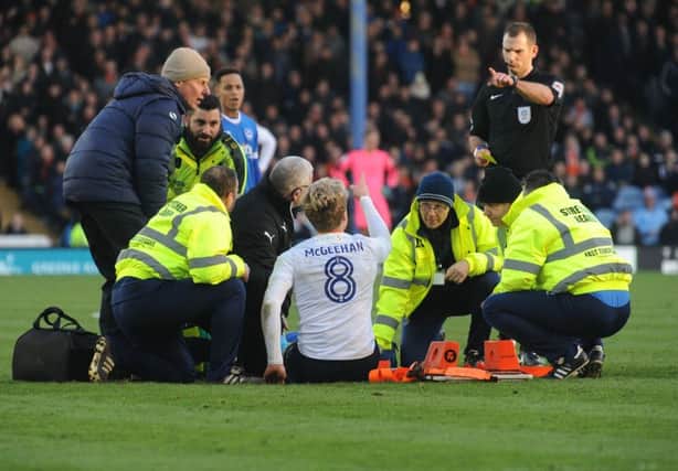 Cameron McGeehan receives treatment against Portsmouth