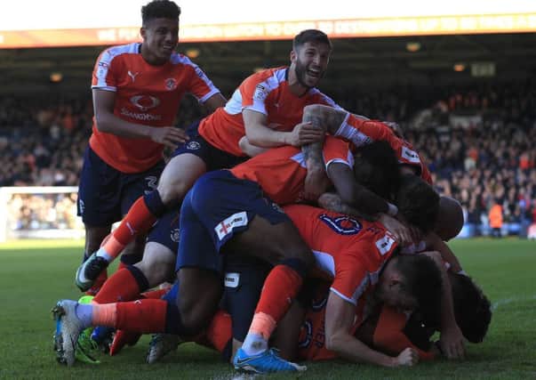 Bundles! Ollie Palmer is under there somewhere after netting his last-gasp winner