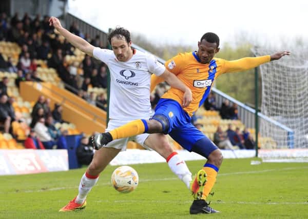 Danny Hylton tussles for possession at Mansfield on Monday