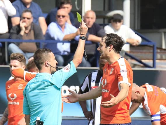 Danny Hylton is shown a yellow card against Notts County