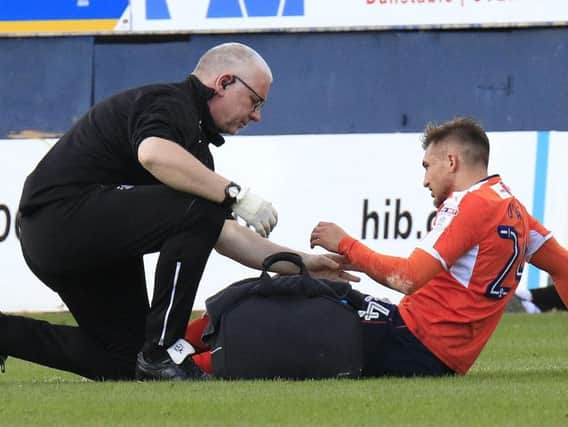 Lawson D'Ath receives treatment from Town physio Simon Parsell