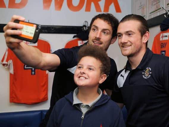Danny Hylton and Jack Marriott take a selfie with a young supporter