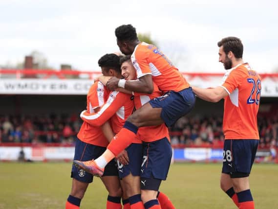 James Justin is mobbed after scoring his first Luton goal