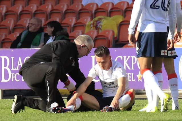 Dan Potts receives treatment for his injury