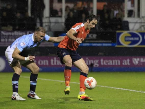Town striker Danny Hylton shields the ball against Blackpool