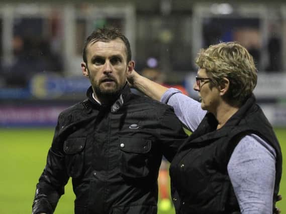 Hatters boss Nathan Jones is consoled after the play-off exit against Blackpool