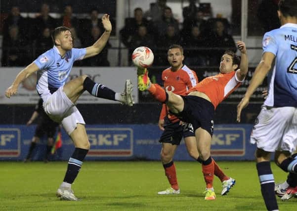 Town striker Danny Hylton tries to win possession against Blackpool