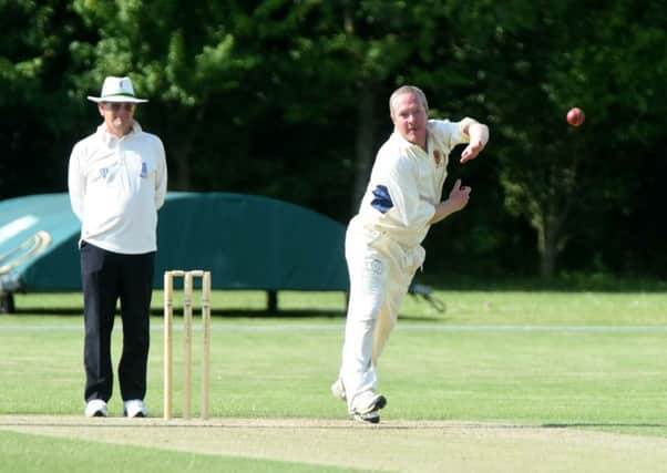 Dunstable bowler Robert Simpkins in action aganist Flitwick