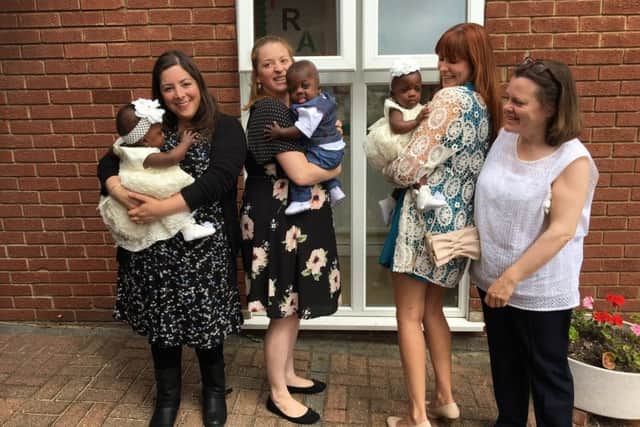 The triplets with the nurses from the Luton and Dunstable Hospital NICU on their Christening day
