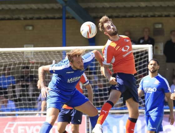 Andrew Shinnie goes up for a header against Bedford