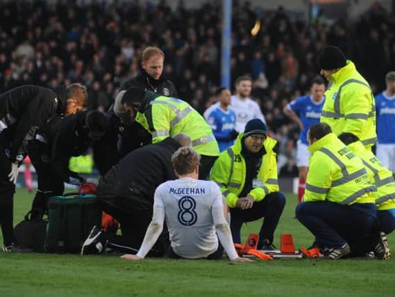 Cameron McGeehan receives treatment against Portsmouth