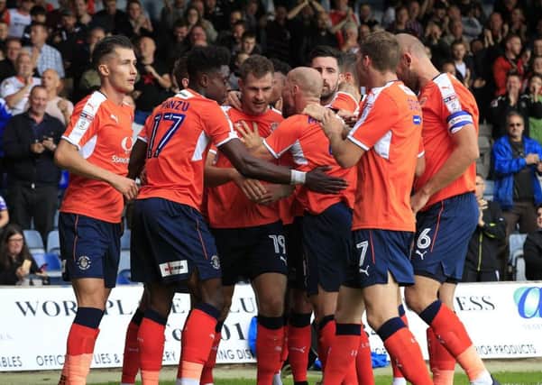 Hatters striker James Collins is mobbed after his first goal