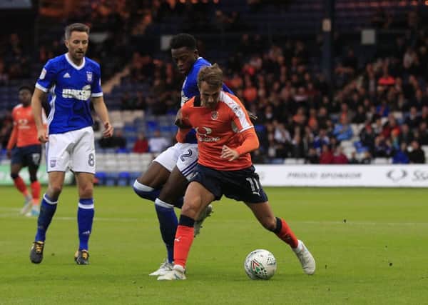 Andrew Shinnie holds off an Ipswich challenge on Tuesday night