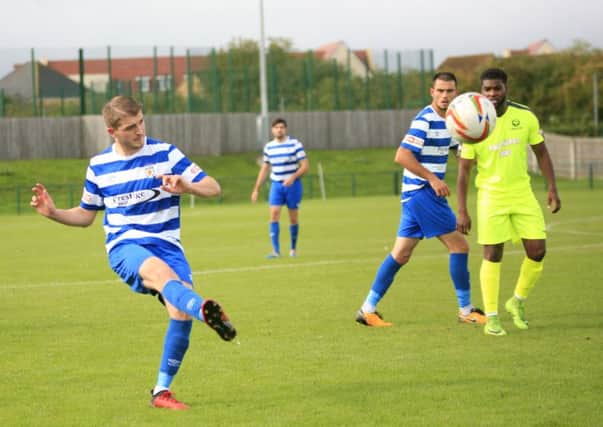 Ben Collins chips the ball forward against Bedford