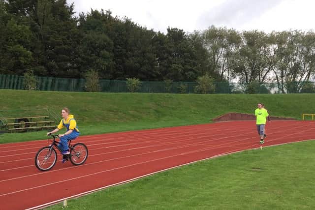 Relay team members tackle the athletics track.