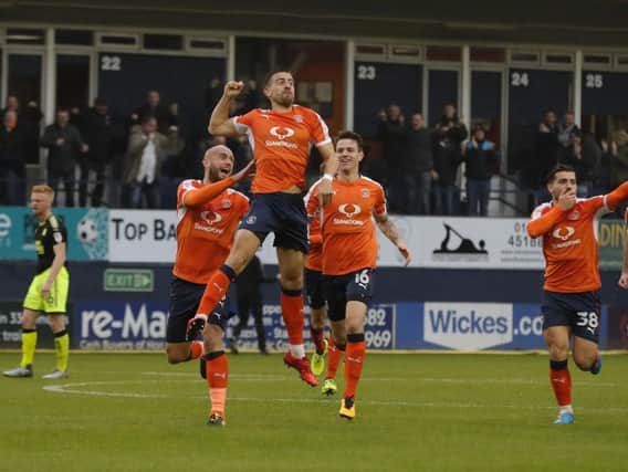 Town midfielder Olly Lee takes to the air after his wonder strike against Cambridge
